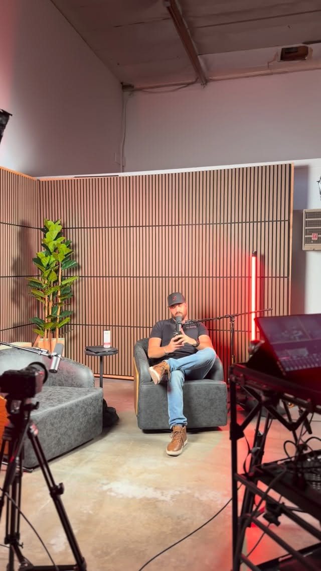 Podcast corner set with acoustic paneled wall and lounge chairs